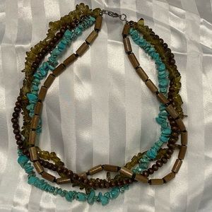 Turquoise and green stones with 2 kinds of wooden beads create this necklace